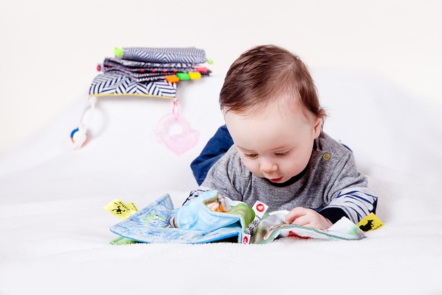 young child programming a small educational robot on a colorful play mat