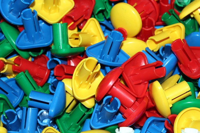 colorful educational toy manufacturing facility with workers assembling STEM kits and building sets